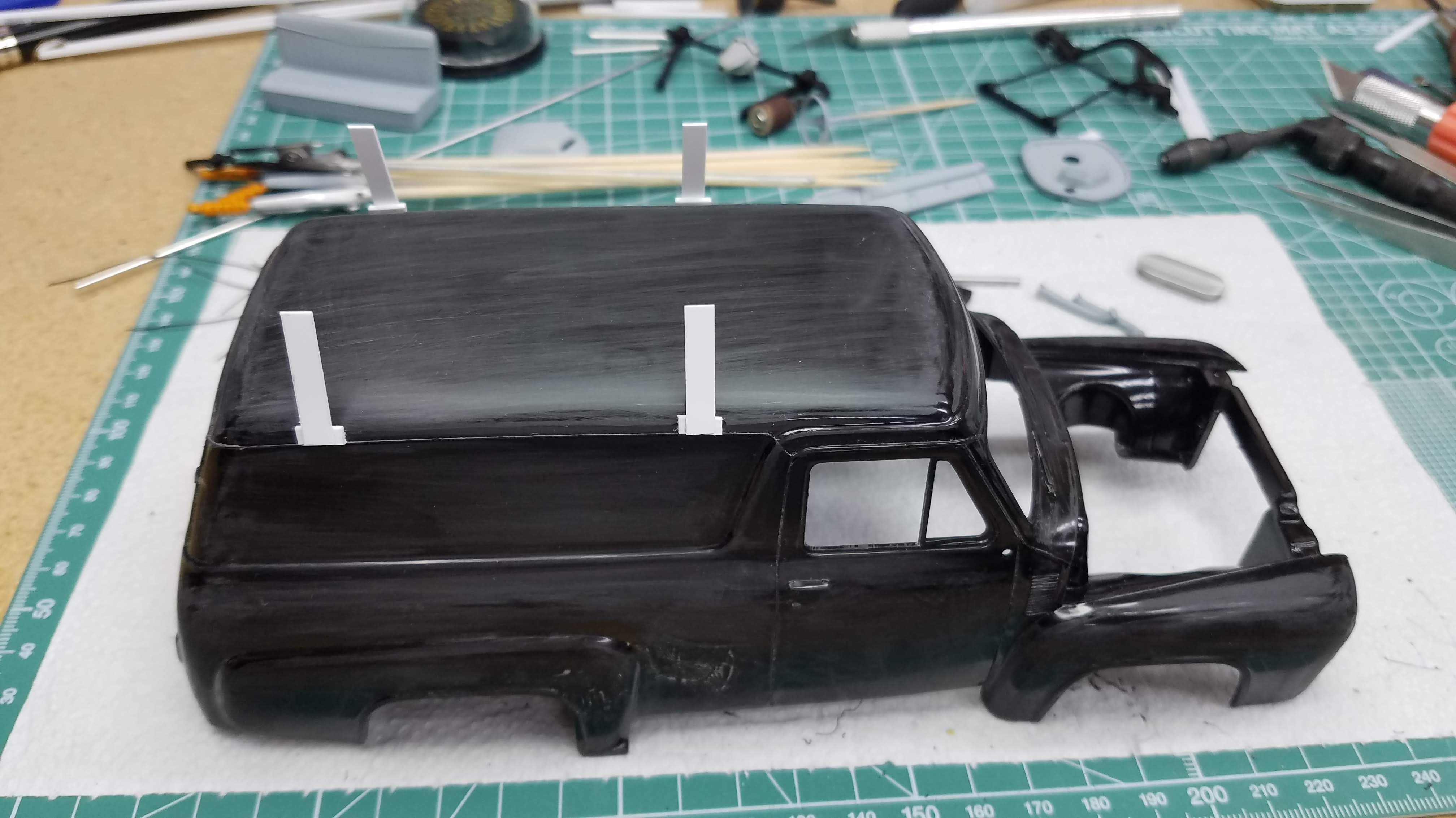 Body sanded and roof rack uprights are installed