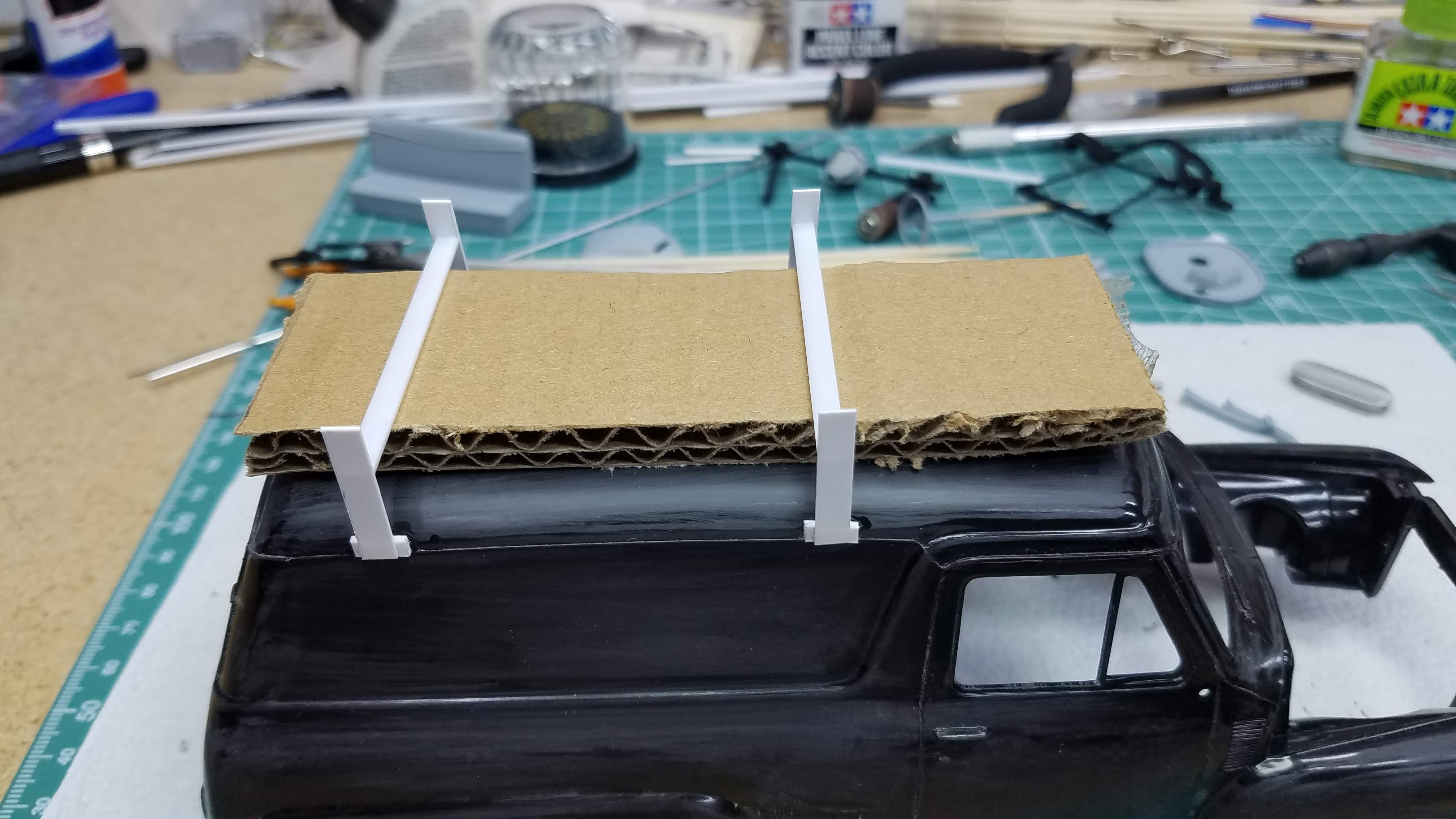 Card board used as a spacer to mount the roof rack cross members.