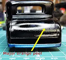 Gloss black portion of body has major orange peel
