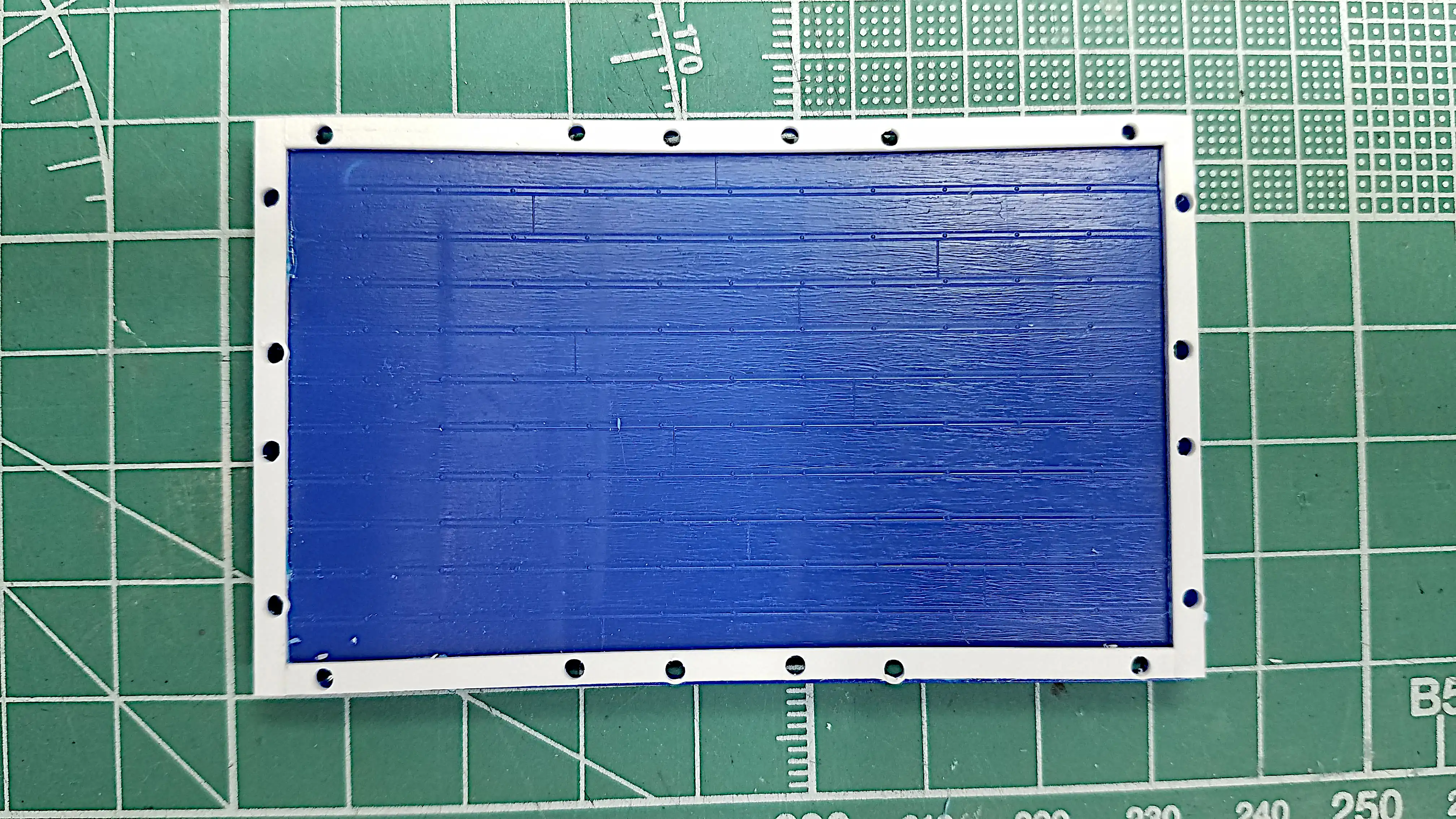Holes are drilled on the bed frame for mounting the scratch built stakes