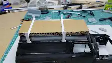 Card board used as a spacer to mount the roof rack cross members.