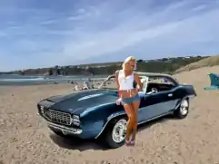 1969 Camaro on the beach with a pretty girl