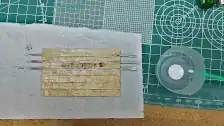 Gluing the seam covers on the balsa wood of the bed