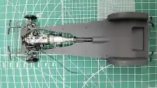 Another view of chassis with engine and front suspension